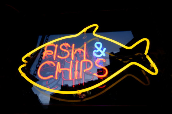Striking yellow & orange neon sign for a fish and chips shop in Brighton